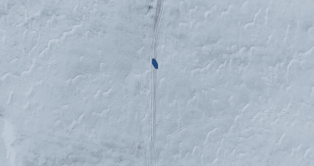 Vehicle traveling across a snowy landscape