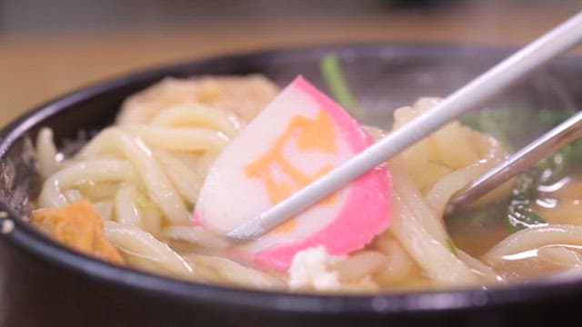 Close-up of udon noodles with fish cake