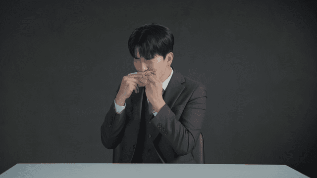 Man smelling money with a satisfied expression
