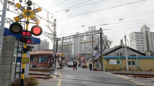 Samgak Baekbin RC with crossing guard in urban area on a cloudy day