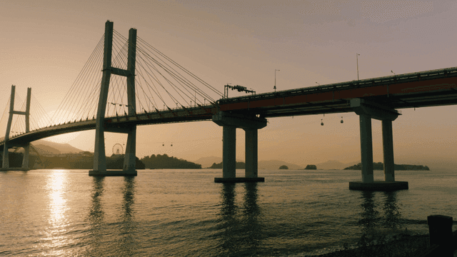 Bridge over a calm river at sunset