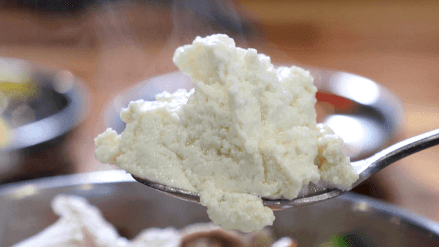 Jjamppong soft tofu scooped up with spoon