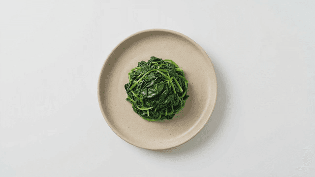 Plate of seasoned fresh spinach