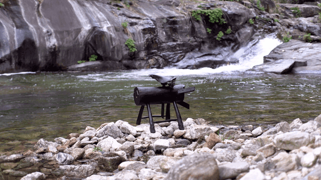 Wooden sculpture by a flowing river