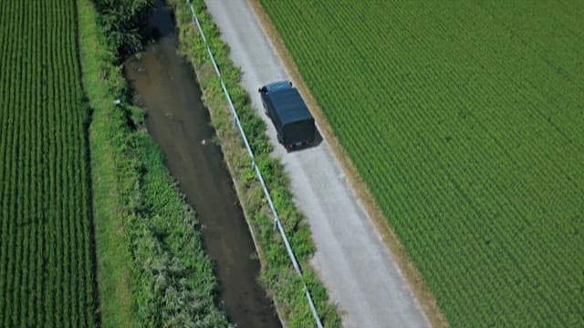 Aerial View of Truck Driving Through Countryside