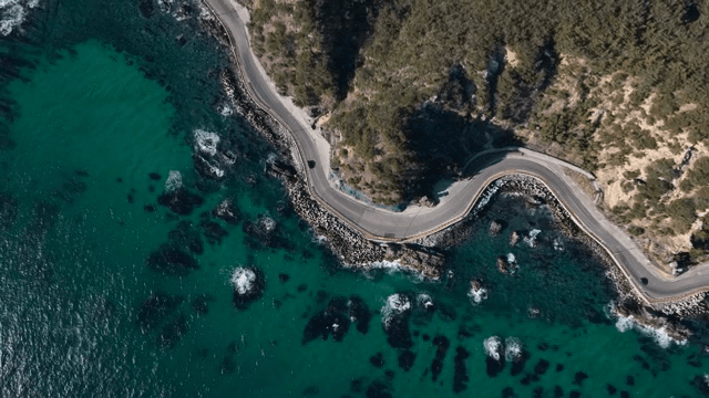 Coastal road winding along the rocky shore