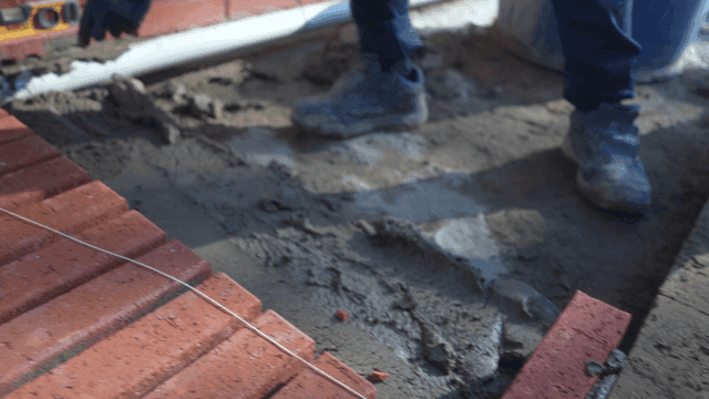 Worker laying bricks with precision