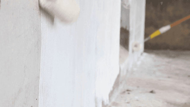 Painting a wall with a roller brush