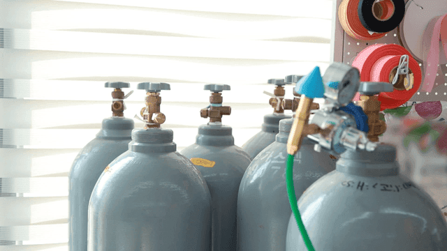 Gas cylinders and colorful tapes in a room