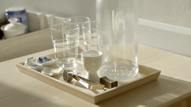 Tray with glasses and tools on table