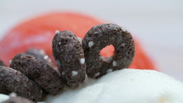 Close-up of chocolate cereal on milk ice cream
