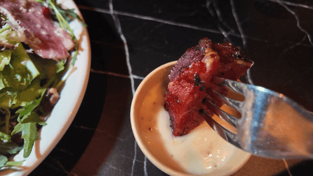 Steak dipped in creamy sauce with salad