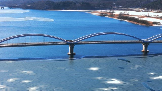 Bridge over the Frozen River during Winter