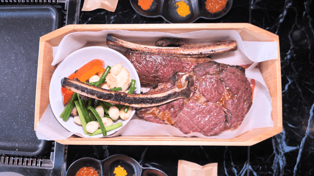 Wooden tray with grilled steak and vegetables