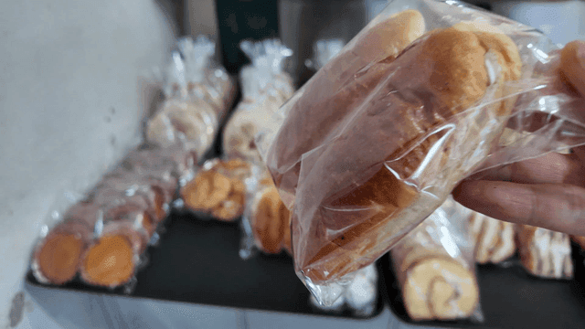 Cream bread chosen in a bakery with packaged breads