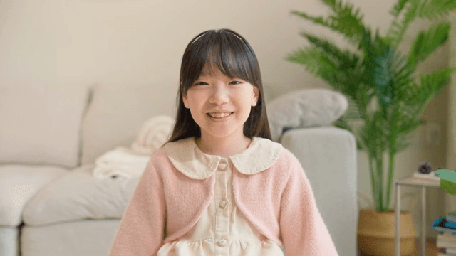 Young girl smiling indoors
