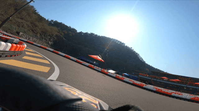 Go-kart racing on a sunny outdoor track