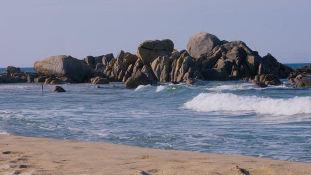 Serene Beach Scene with Rocks and Waves