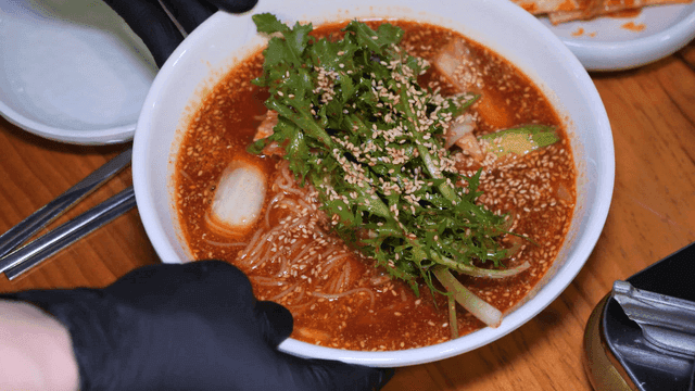 Spicy mixed noodles on table