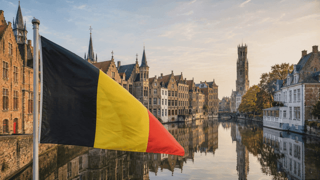 Belgian flag fluttering by canal