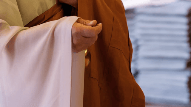 종을 흔들고 있는 승려의 손