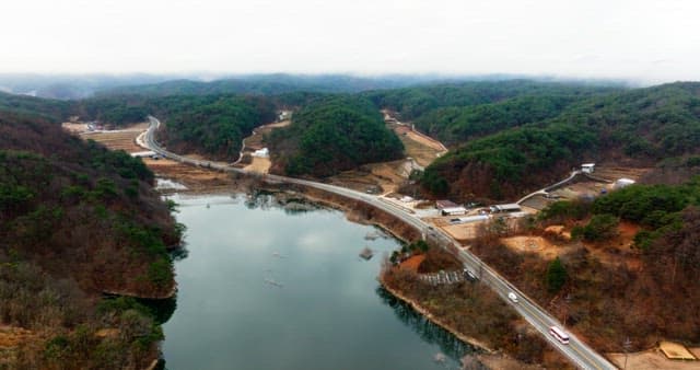 Aerial View of a Winding Road by a Lake