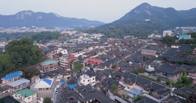 Traditional hanok village with mountains