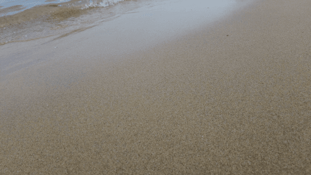 Gentle waves lapping on a sandy shore