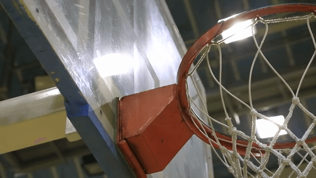 불이 켜진 실내 농구장의 골대