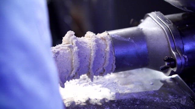 Dough being extruded from a machine