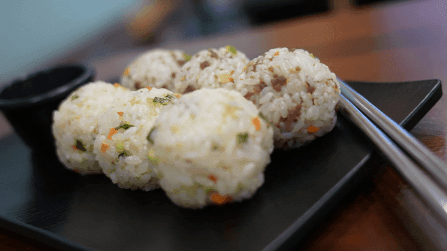 Round rice balls on black plate