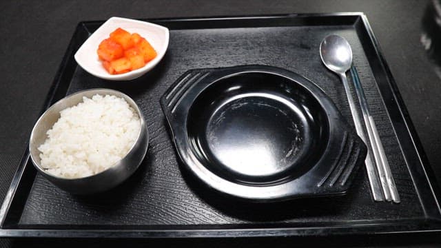 Tray with rice, kimchi, and Korean beef and rice soup