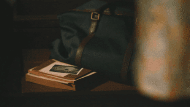 Ultrasound photo next to bag with floral dress and books