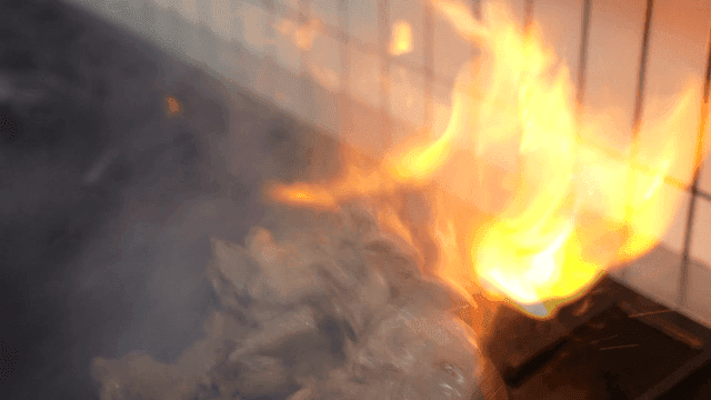 Flames rising from cooking pan