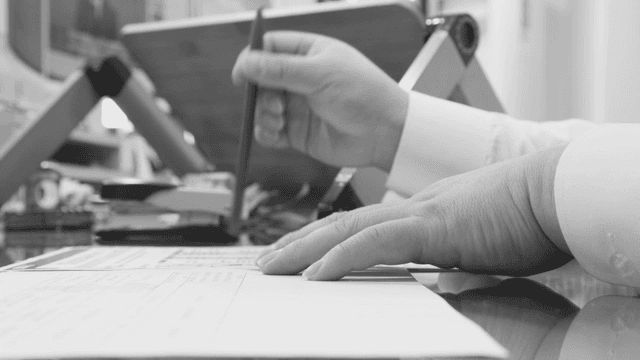 Person working at a desk with documents