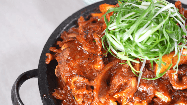 Spicy crunchy braised pork ribs topped with plenty of shredded green onions