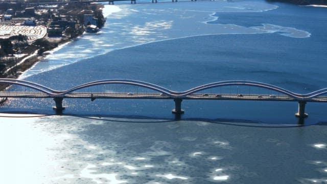 Aerial View of a Bridge Over Frozen River