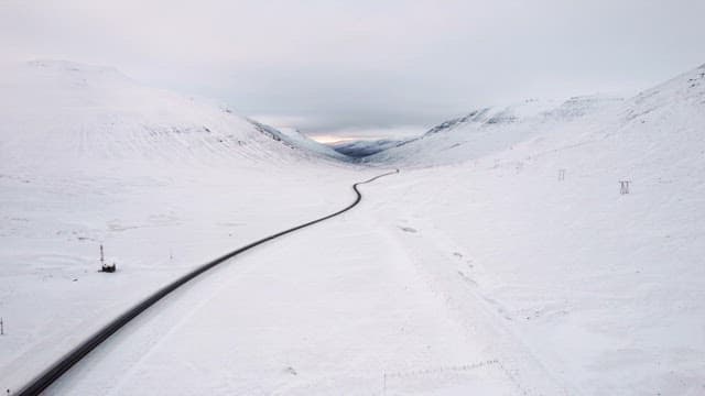 Winding road through snowy mountains