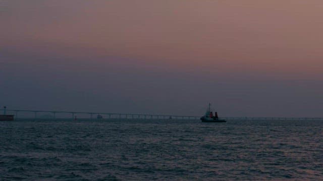 Ship sailing under the evening sky at sunset