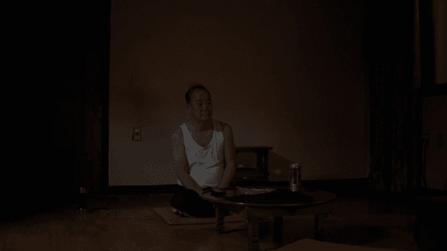 Man sitting in dark living room