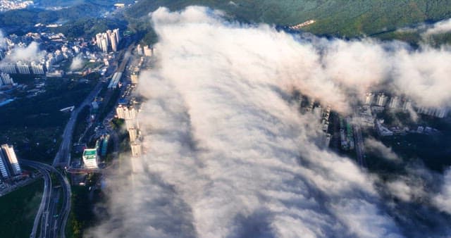 Cityscape with clouds covering buildings