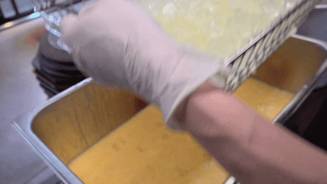 Egg mixture in metal tray fallen beneath ice