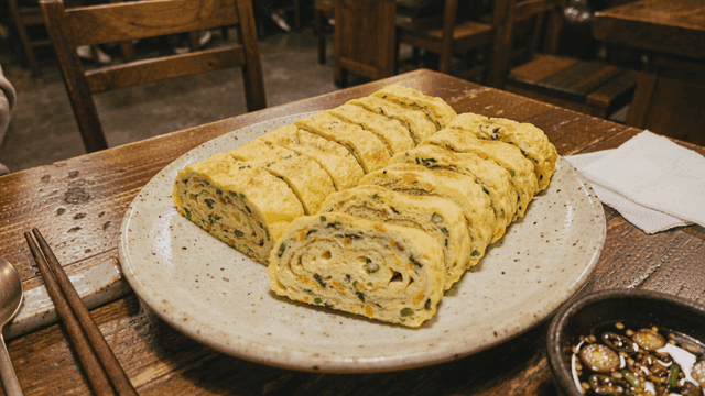 Korean rolled omelette on a plate in a cozy restaurant