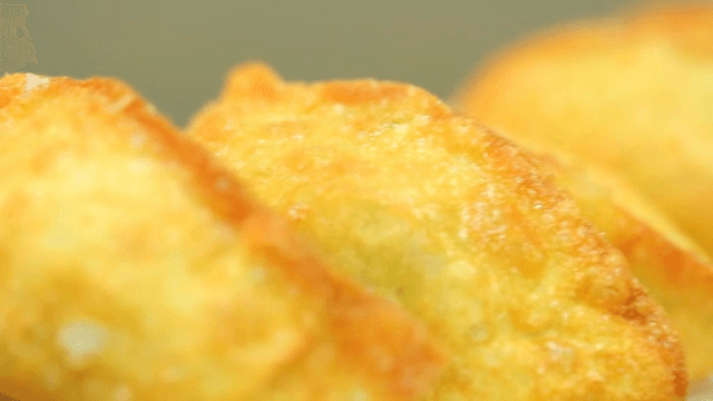 Pan-fried mandu on a white plate