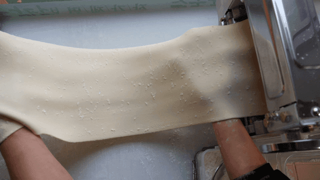 Dough coming out of noodle maker