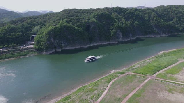 Cruise Ship Navigating a Scenic River