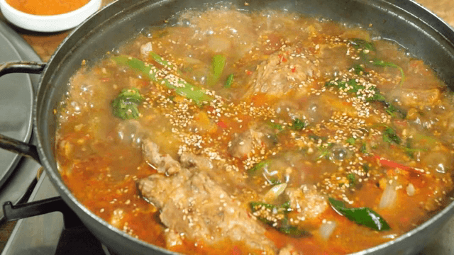 Spicy Braised Pork Galbi boiling in a pot