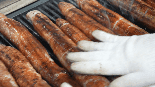 Turning on grill with gloves makchang sausage