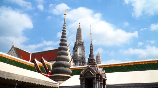 Ornate Thai temple spires under blue sky