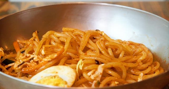 Spicy and Sour Jjolmyeon in a Large Brass Bowl